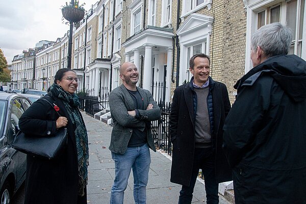 Christophe with Cllr Tim Verboven and Hina Bokhari AM talking to a resident