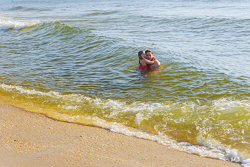 Two young people swimming in the sea